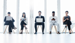 Shot of a group of businesspeople using digital devices in an office.